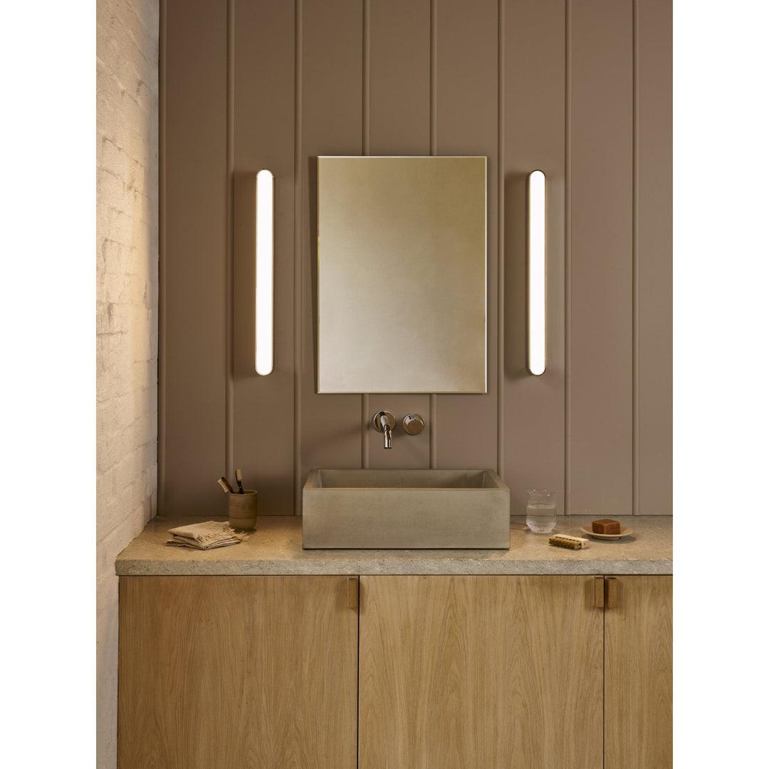 Mirror wall lamp installed beside a luxury hotel bathroom mirror providing balanced illumination.