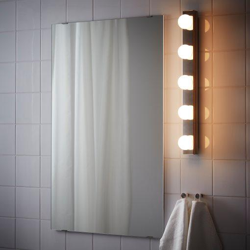 Mirror wall lamp installed beside a luxury hotel bathroom mirror providing balanced illumination.