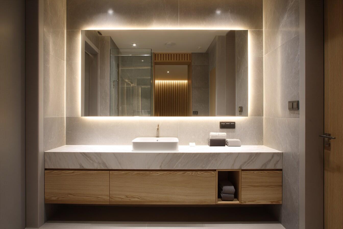 Mirror wall lamp installed beside a luxury hotel bathroom mirror providing balanced illumination.