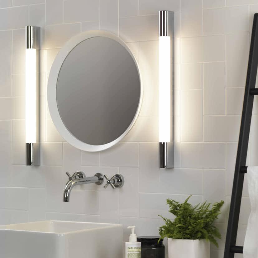 Mirror wall lamp installed beside a luxury hotel bathroom mirror providing balanced illumination.