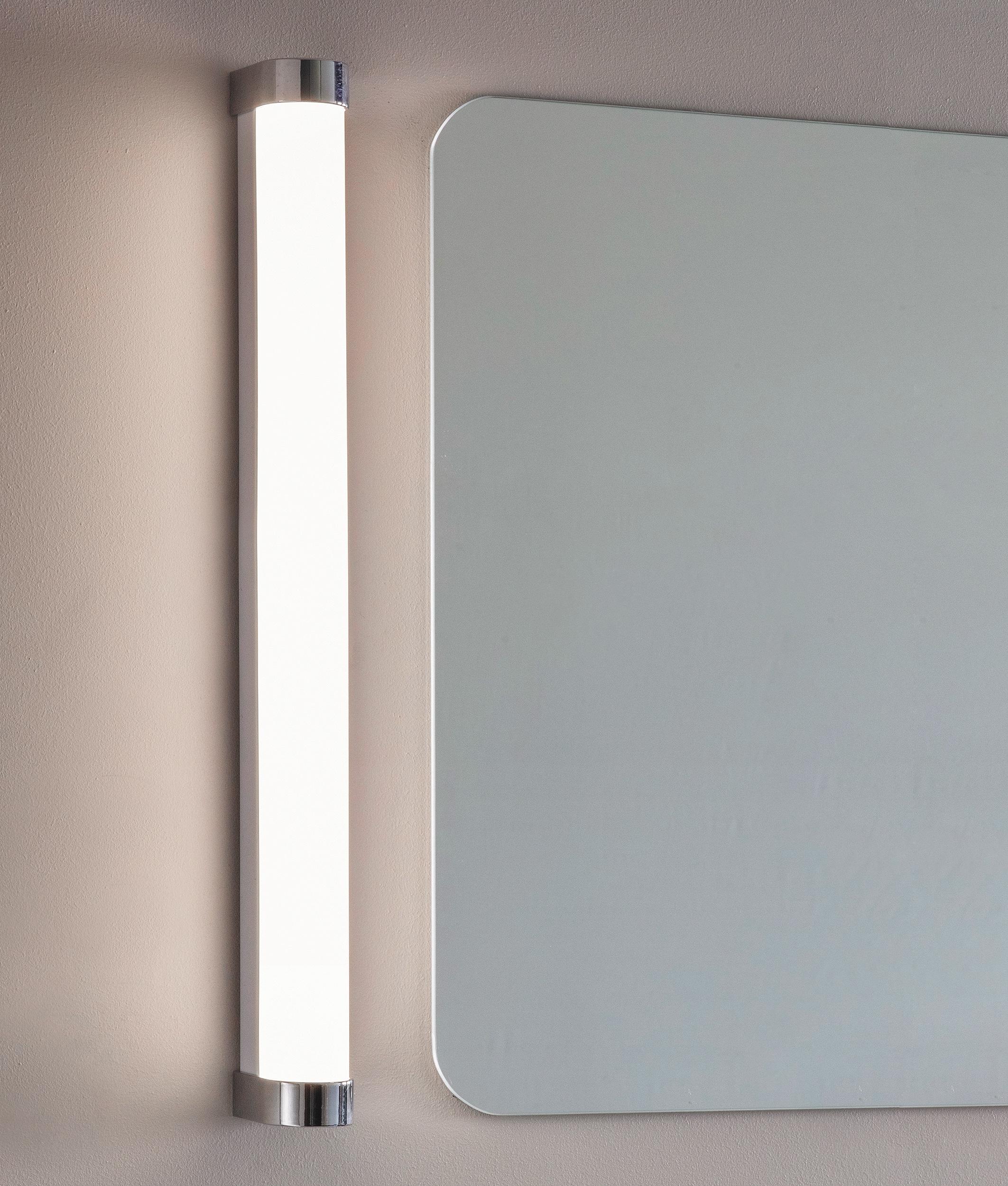 Mirror wall lamp installed beside a luxury hotel bathroom mirror providing balanced illumination.