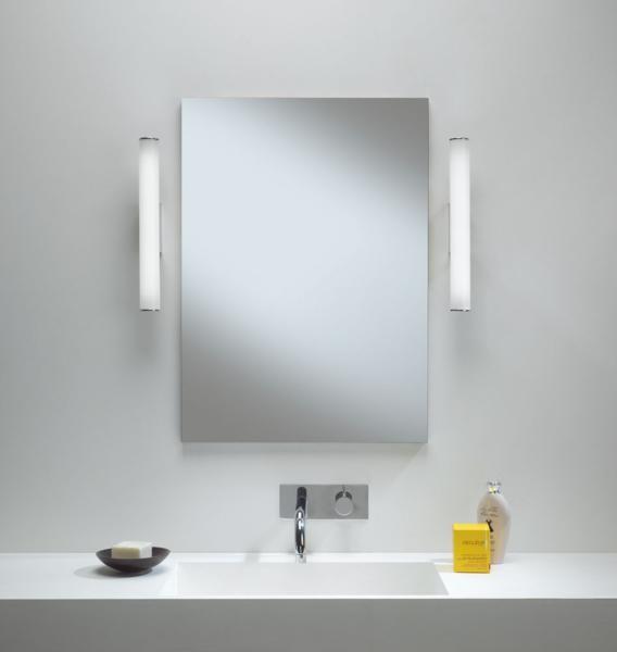 Mirror wall lamp installed beside a luxury hotel bathroom mirror providing balanced illumination.