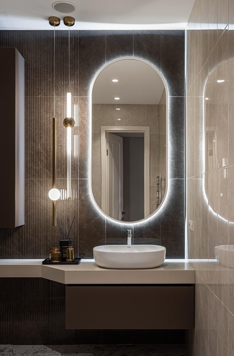 Mirror wall lamp installed beside a luxury hotel bathroom mirror providing balanced illumination.
