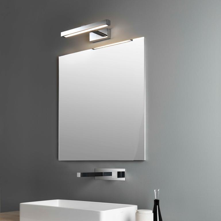 Mirror wall lamp installed beside a luxury hotel bathroom mirror providing balanced illumination.