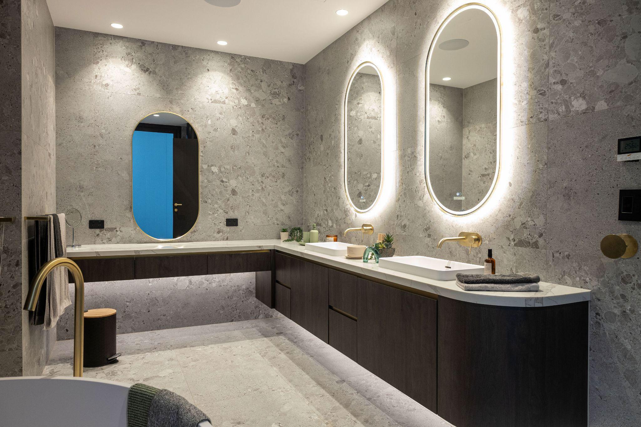 Mirror wall lamp installed beside a luxury hotel bathroom mirror providing balanced illumination.