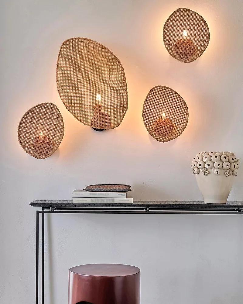 Woven wall lamp installed in a luxury resort interior with contemporary natural architecture.