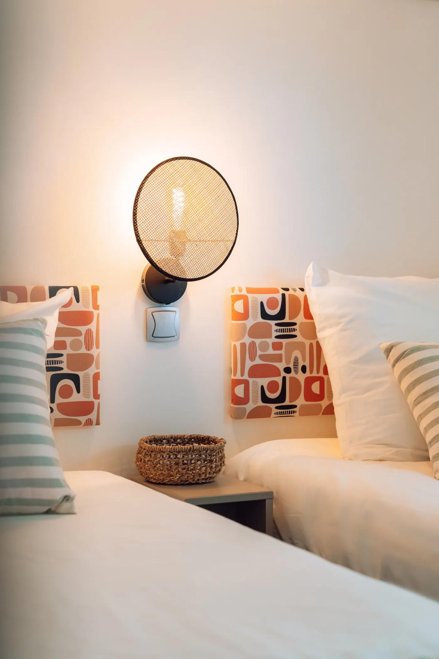 Woven wall lamp installed in a luxury resort interior with contemporary natural architecture.