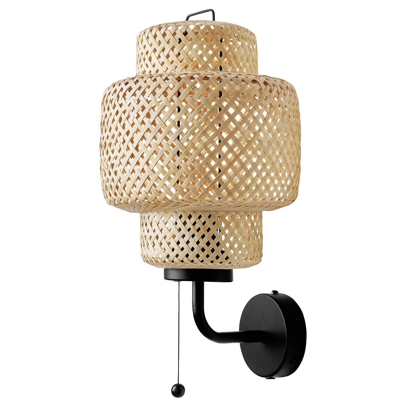 Handwoven rattan wall lamp photographed on a clean white studio background.