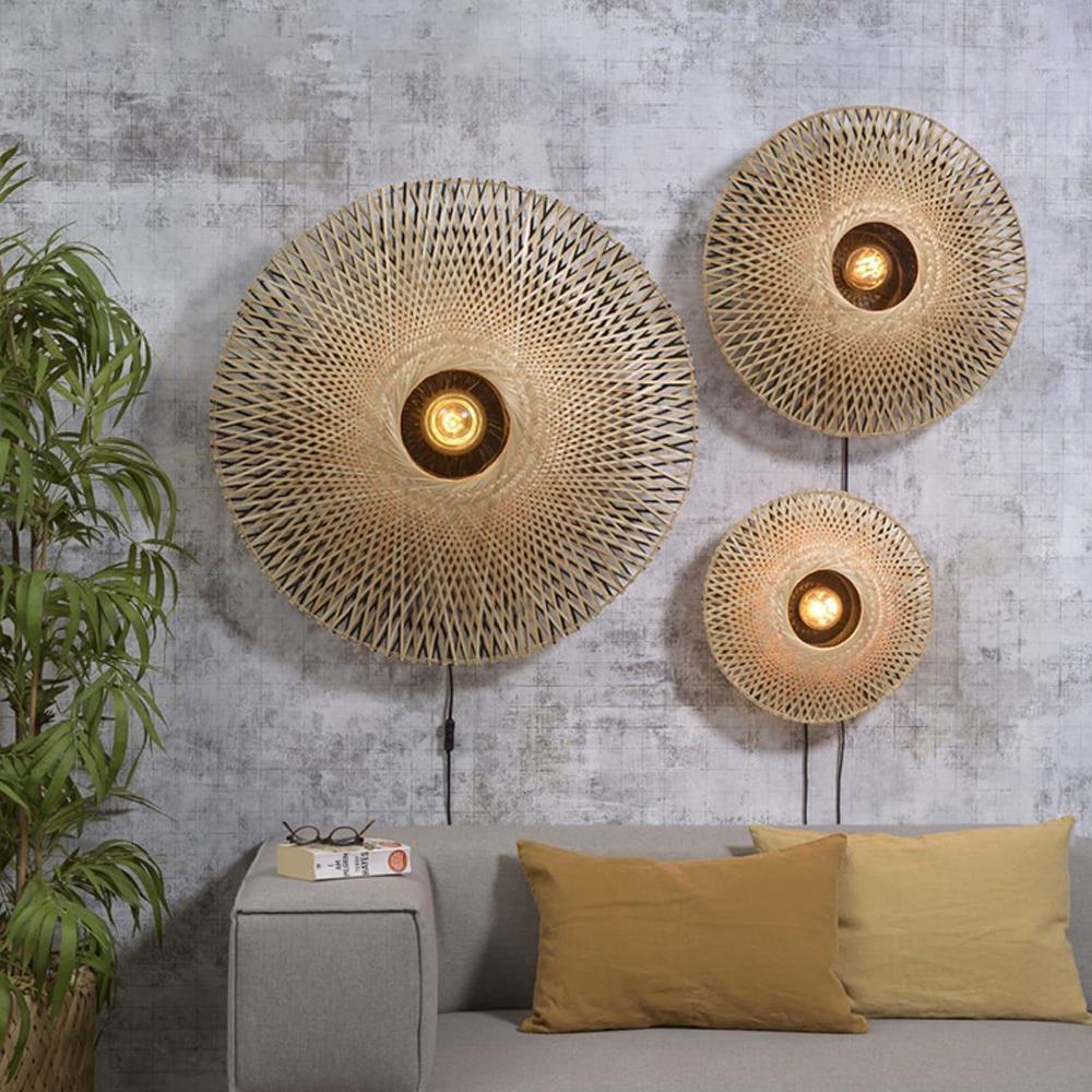 Woven wall lamp installed in a luxury resort interior with contemporary natural architecture.
