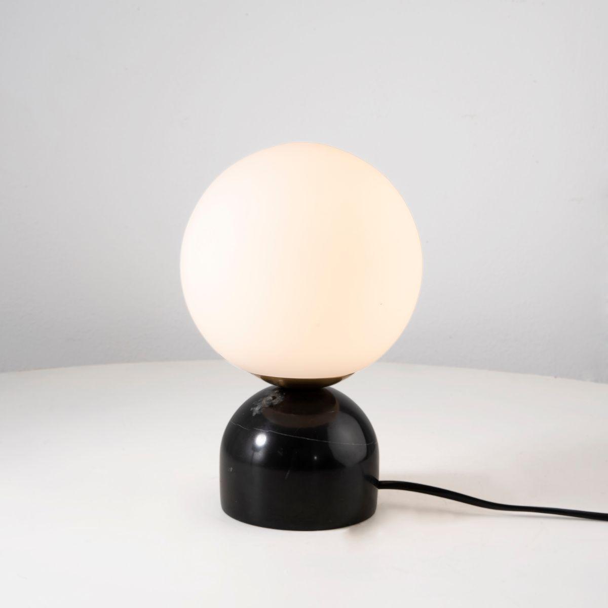 Front view of a globe table lamp highlighting the elegant spherical form and refined architectural design.