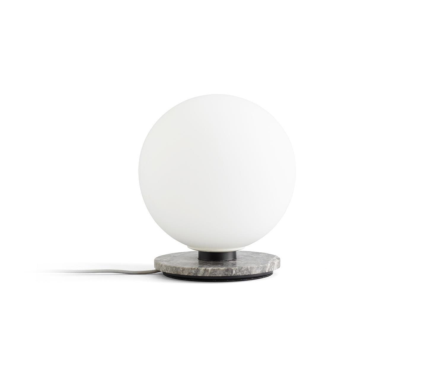 Globe table lamp photographed on a clean white background showcasing its opal spherical diffuser and premium base.