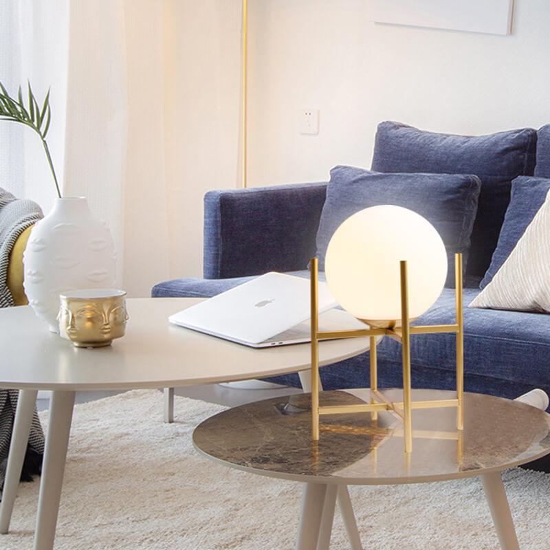 Globe table lamp placed on a luxury hotel bedside table creating soft and balanced ambient illumination.