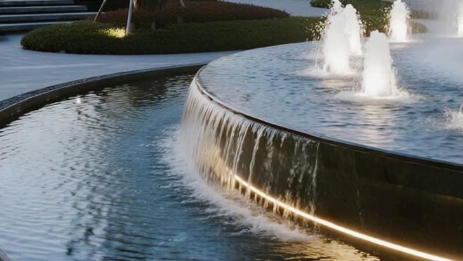 LED underwater linear lights illuminating a fountain and architectural water feature.