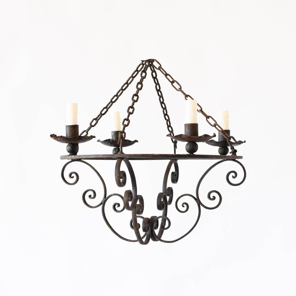 Rustic chandelier featuring wood and wrought iron photographed on a clean white studio background.