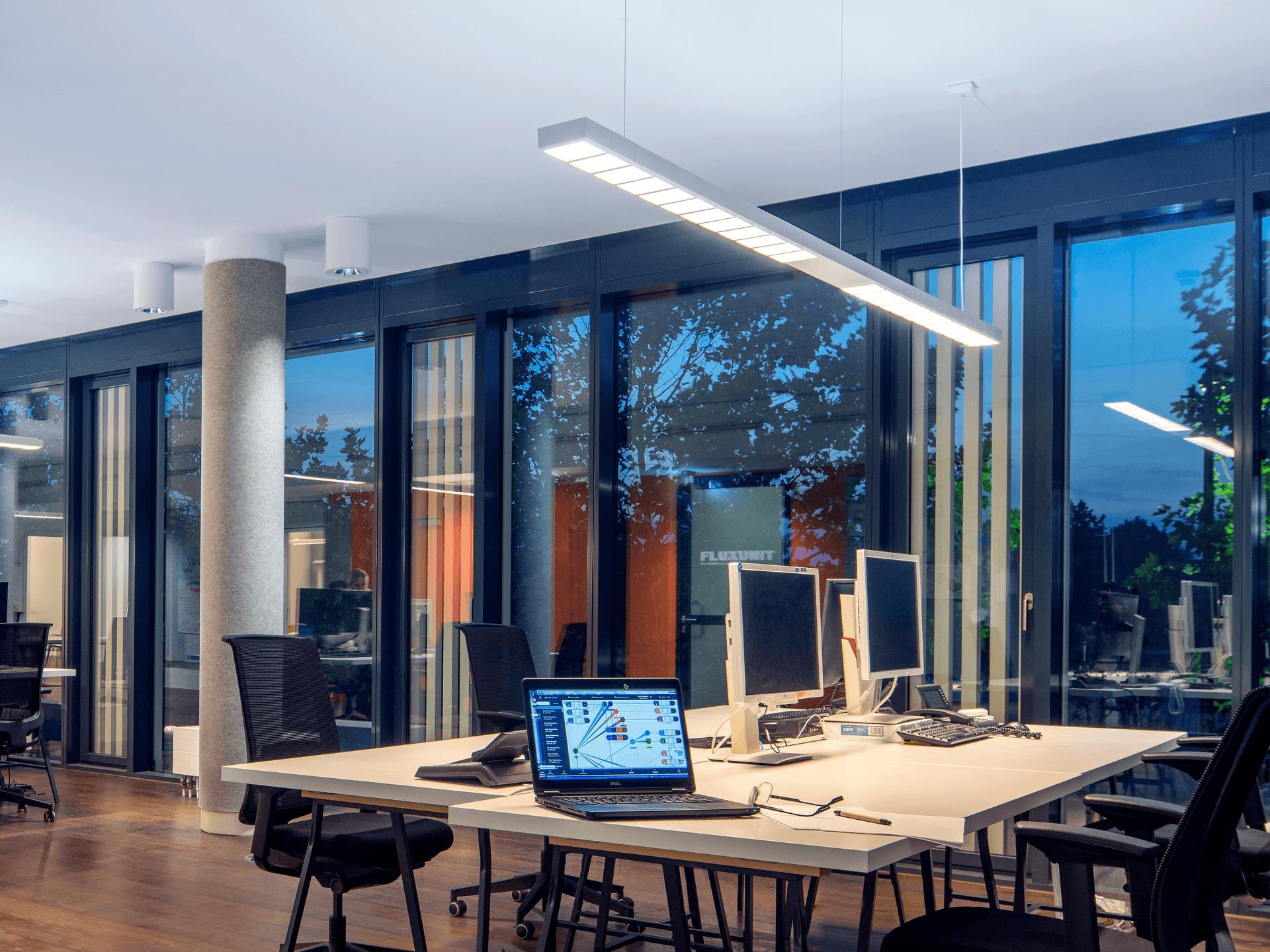 Human centric suspended linear lights installed in a contemporary office environment.