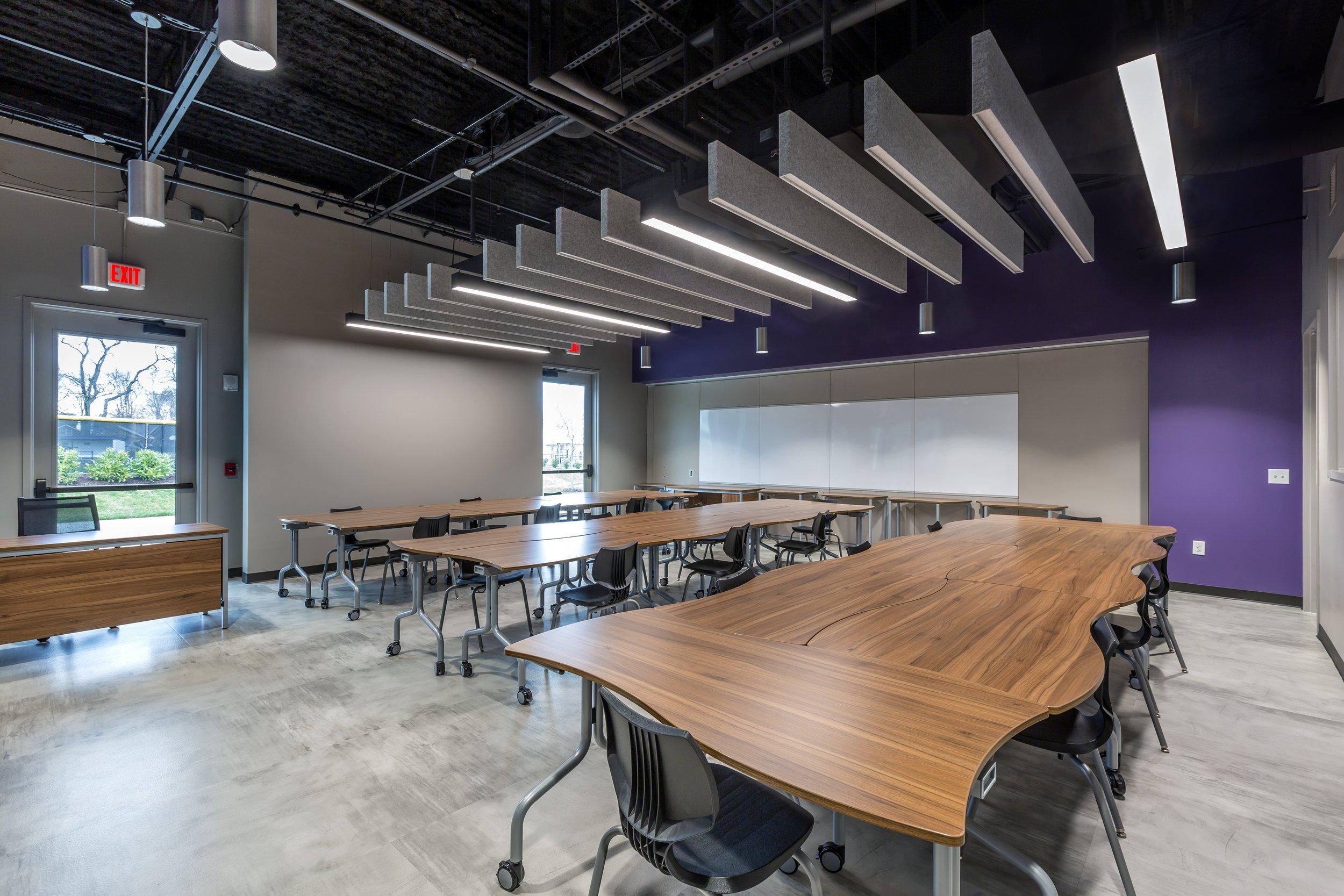 Acoustic pendant lighting installed in a modern office workspace.