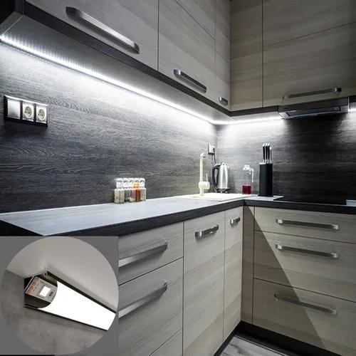 Corner LED profiles installed beneath kitchen cabinets in a contemporary residential interior.