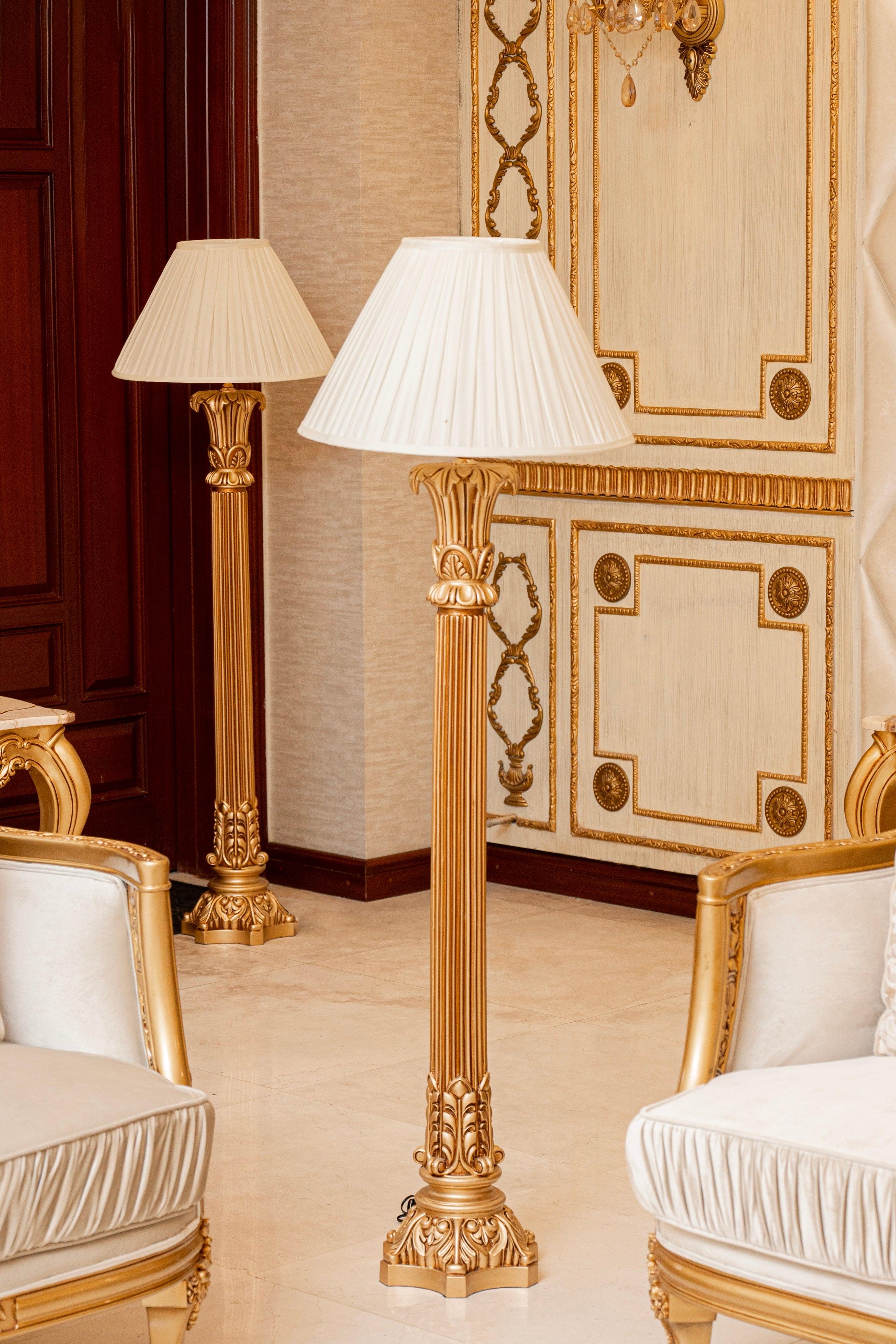 Classic floor lamp positioned beside a seating area in a luxury hotel lounge, creating warm ambient lighting and timeless sophistication.