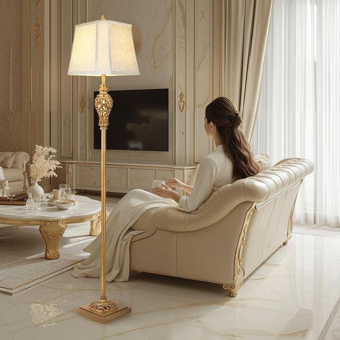 Classic floor lamp positioned beside a seating area in a luxury hotel lounge, creating warm ambient lighting and timeless sophistication.