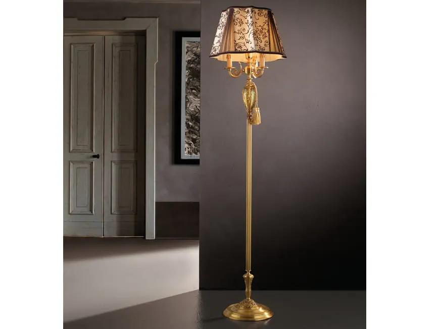 Classic floor lamp positioned beside a seating area in a luxury hotel lounge, creating warm ambient lighting and timeless sophistication.