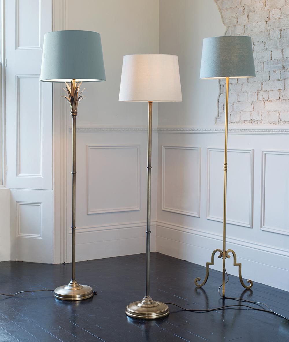 Collection of classic floor lamps featuring brass, ceramic and fabric shade combinations for elegant residential and hospitality interiors.