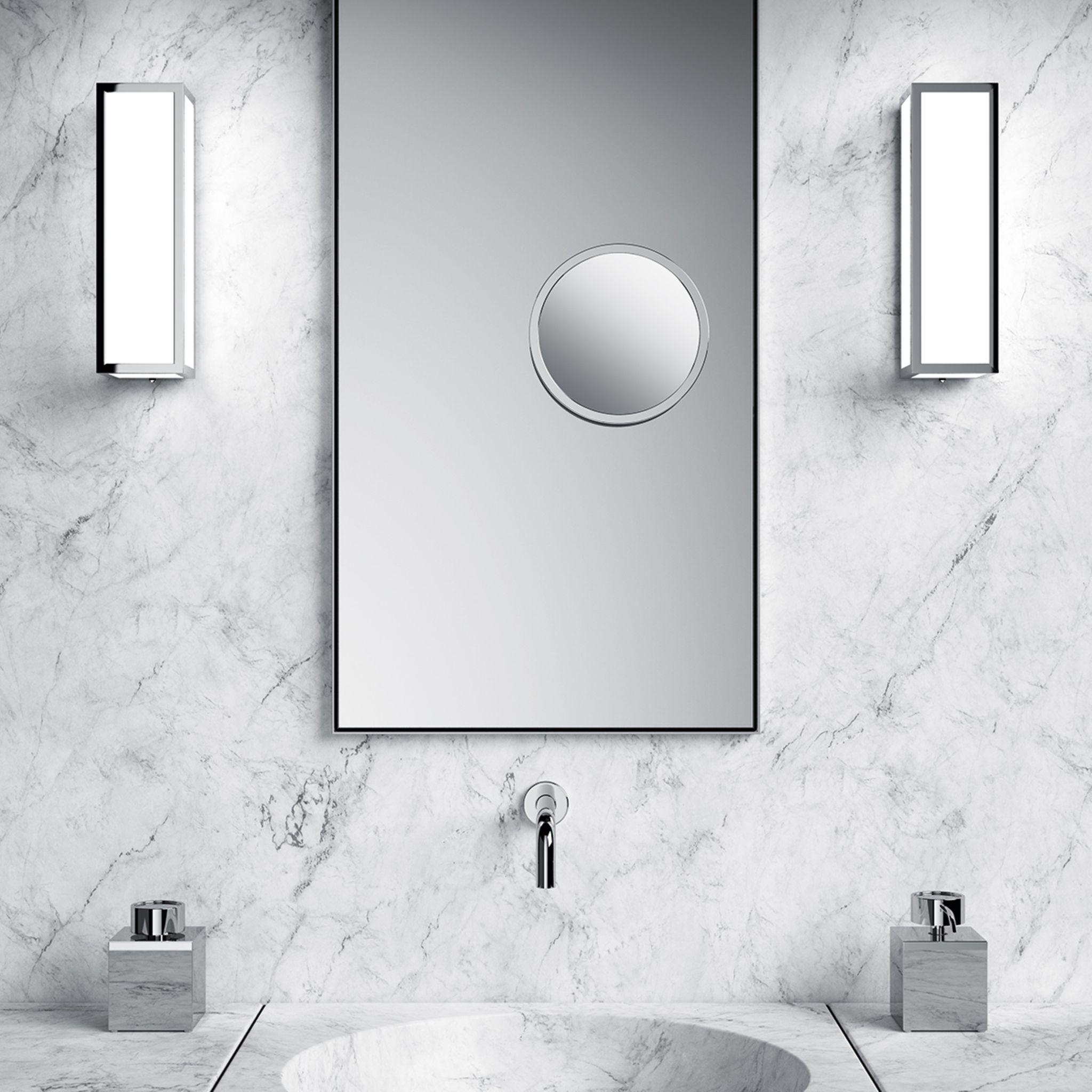 Bathroom wall lamp installed in a luxury hotel bathroom creating soft, balanced architectural lighting.