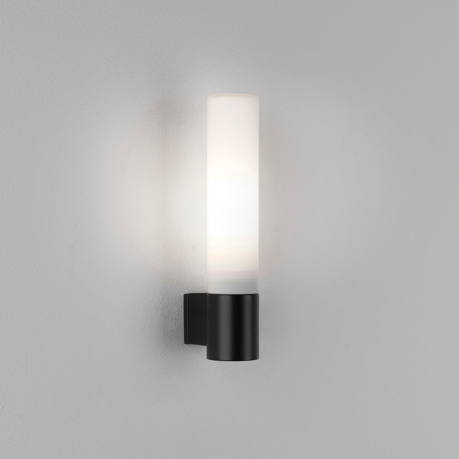 Front view of a decorative bathroom wall lamp with diffused architectural illumination.