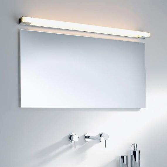 Bathroom wall lamp installed in a luxury hotel bathroom creating soft, balanced architectural lighting.