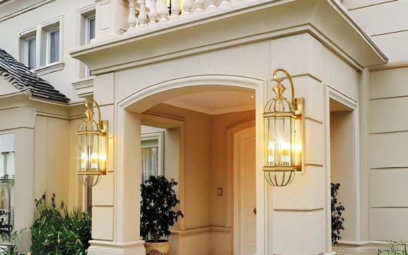 Lantern wall lamp installed beside the entrance of a luxury residence with timeless architectural styling.