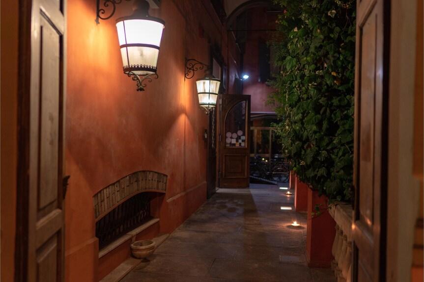 Lantern wall lamp installed beside the entrance of a luxury residence with timeless architectural styling.