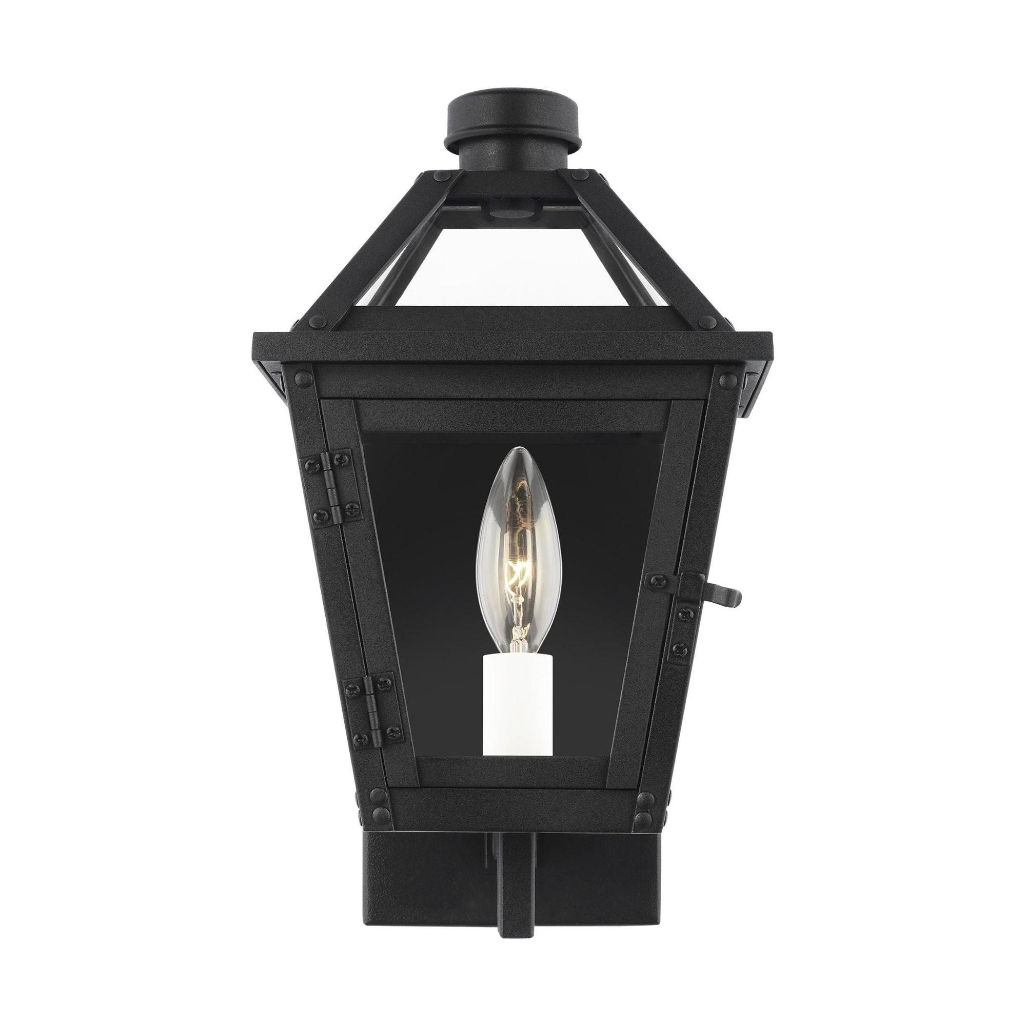 Lantern wall lamp photographed on a clean white studio background featuring a geometric metal frame.