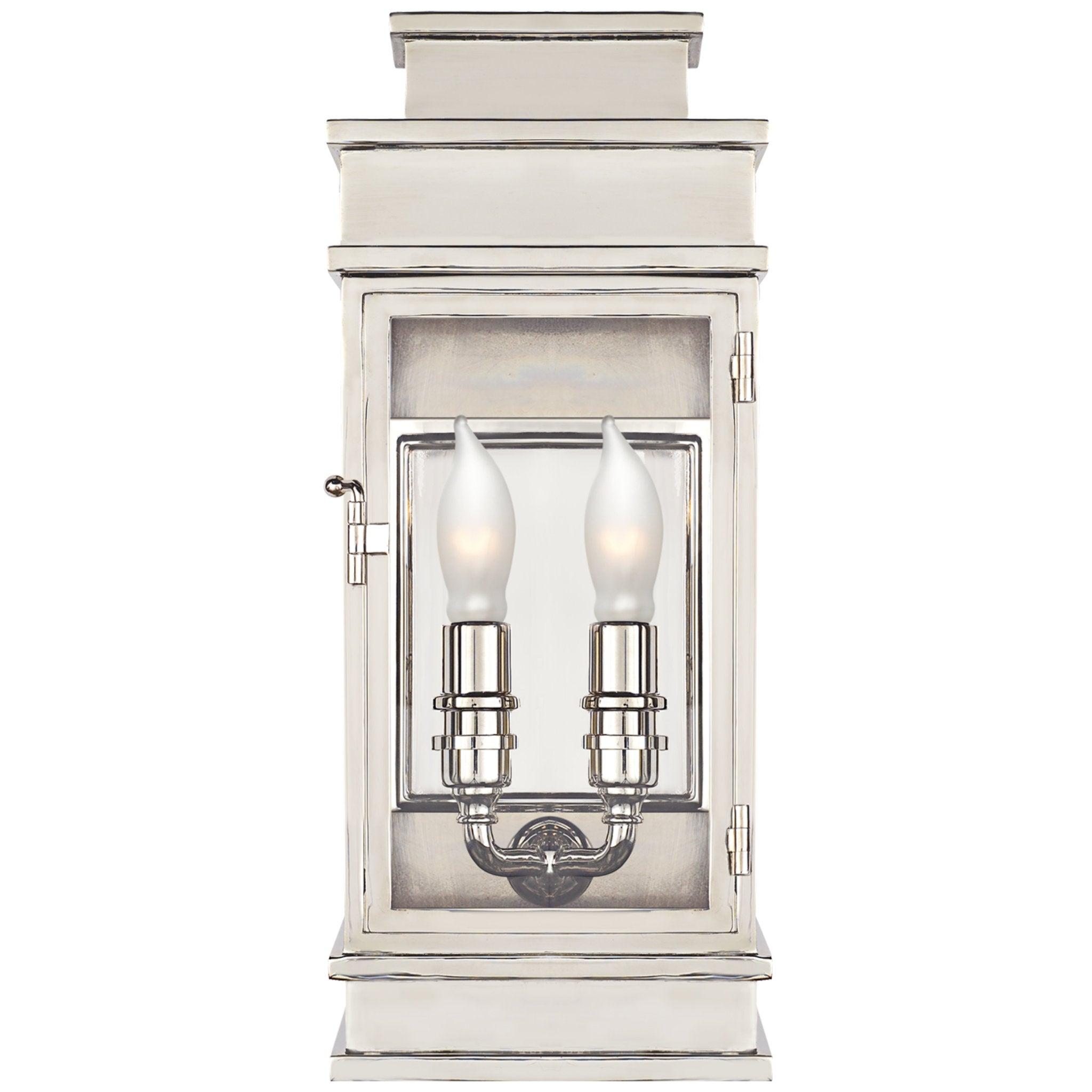 Lantern wall lamp photographed on a clean white studio background featuring a geometric metal frame.