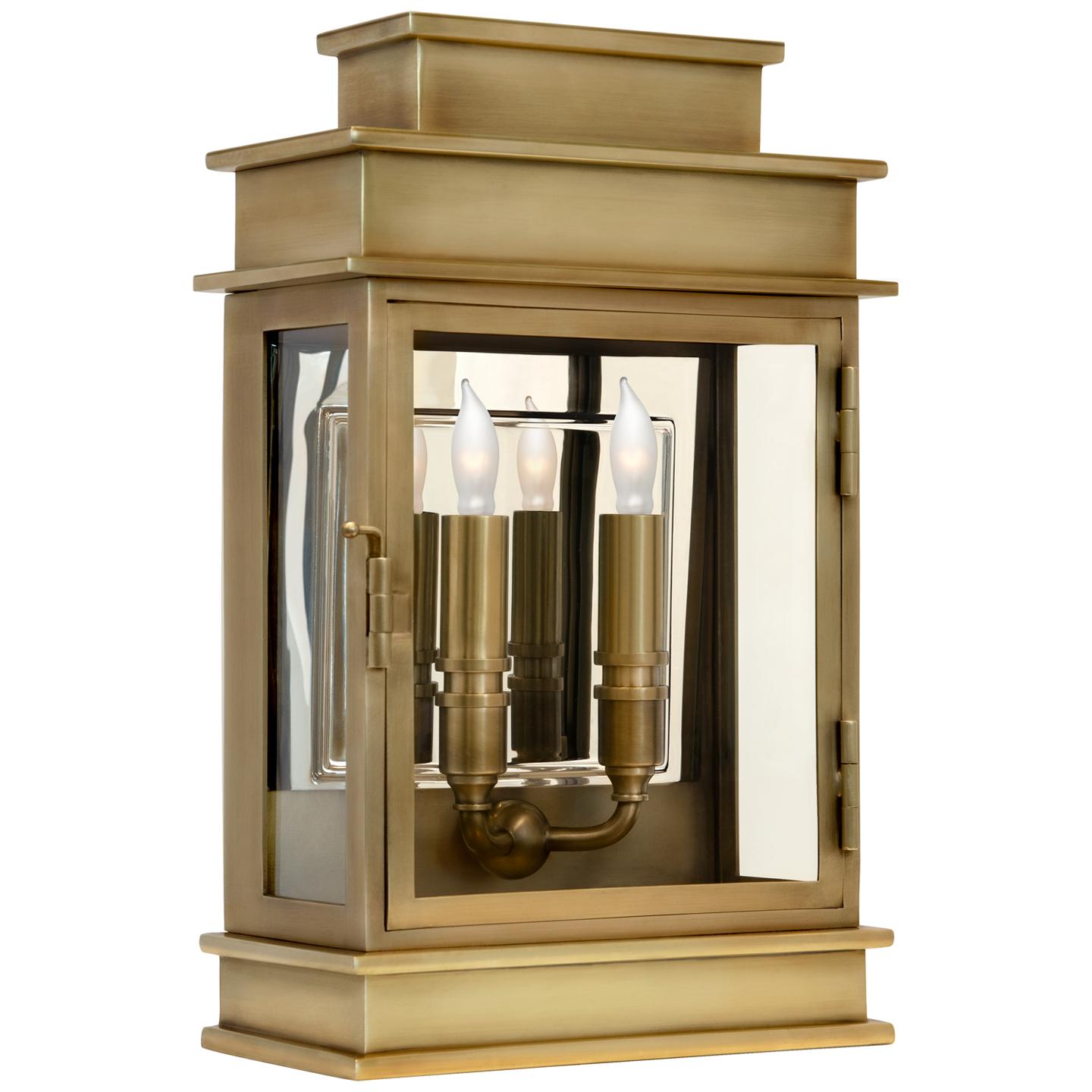 Lantern wall lamp photographed on a clean white studio background featuring a geometric metal frame.