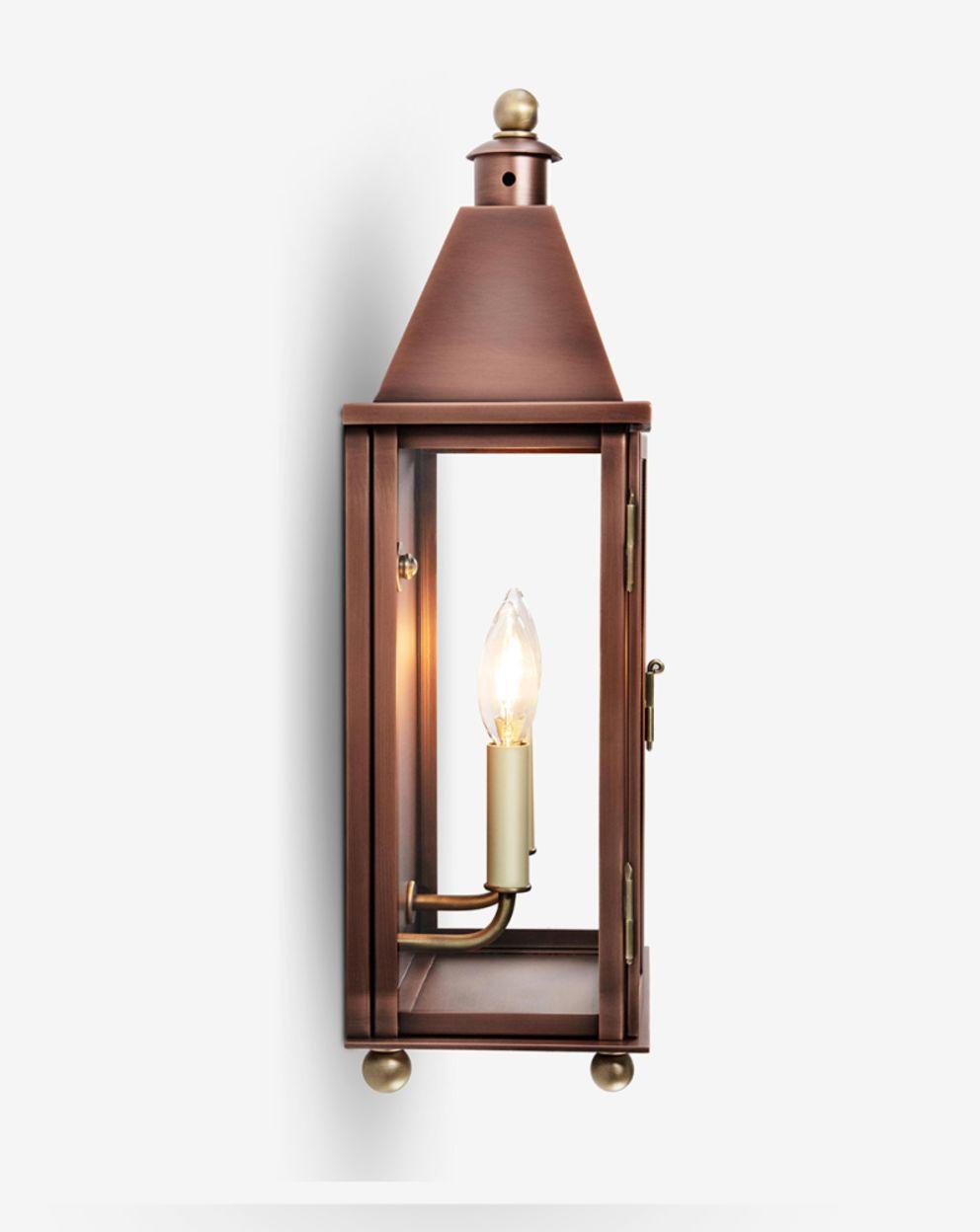 Front view of a lantern-style wall lamp with elegant glass and metal detailing.