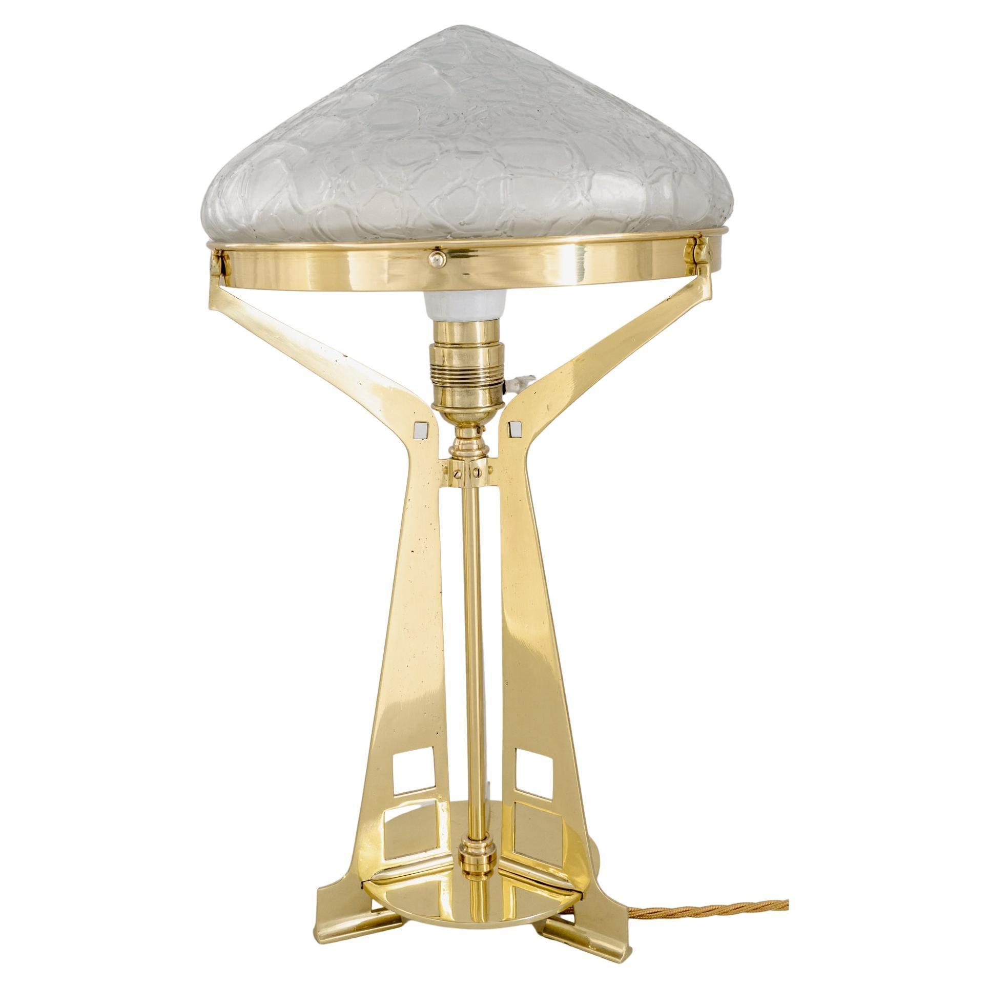 Art Deco table lamp photographed on a clean white background showcasing geometric forms, luxurious materials and elegant finishes.