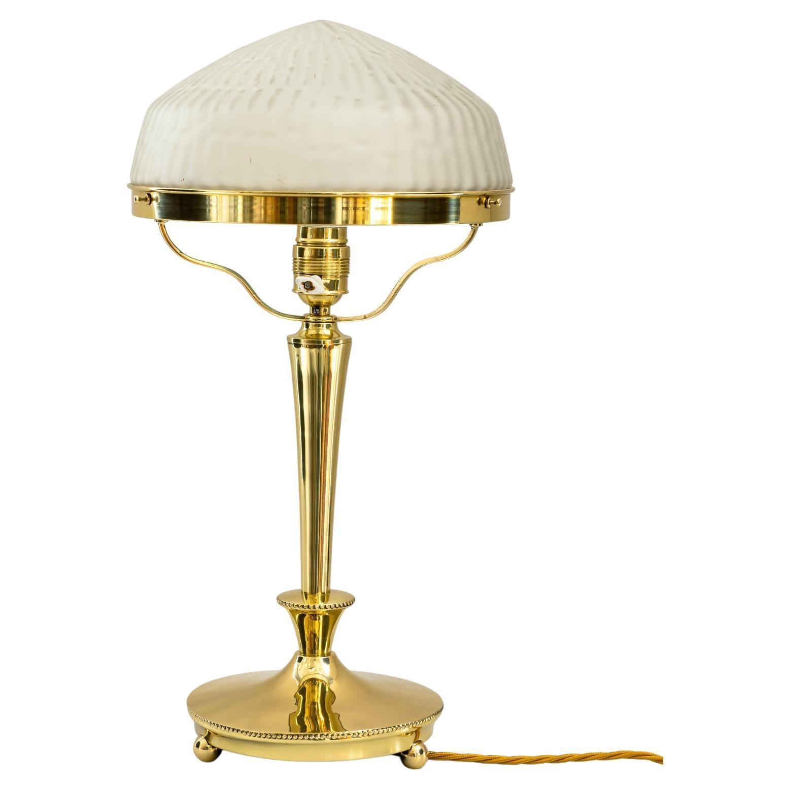 Art Deco table lamp photographed on a clean white background showcasing geometric forms, luxurious materials and elegant finishes.