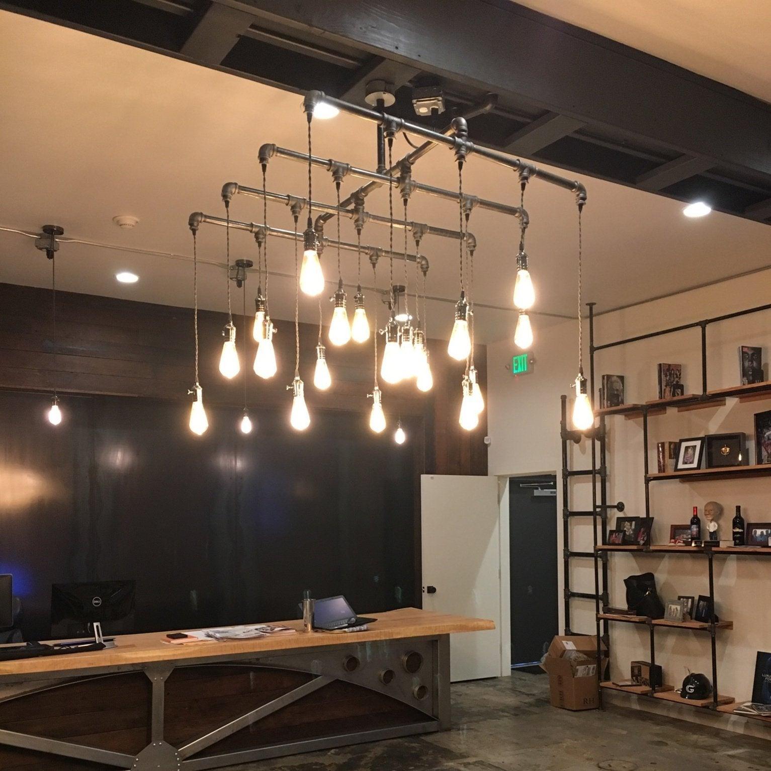 Industrial chandelier installed in a contemporary restaurant with industrial architectural styling.