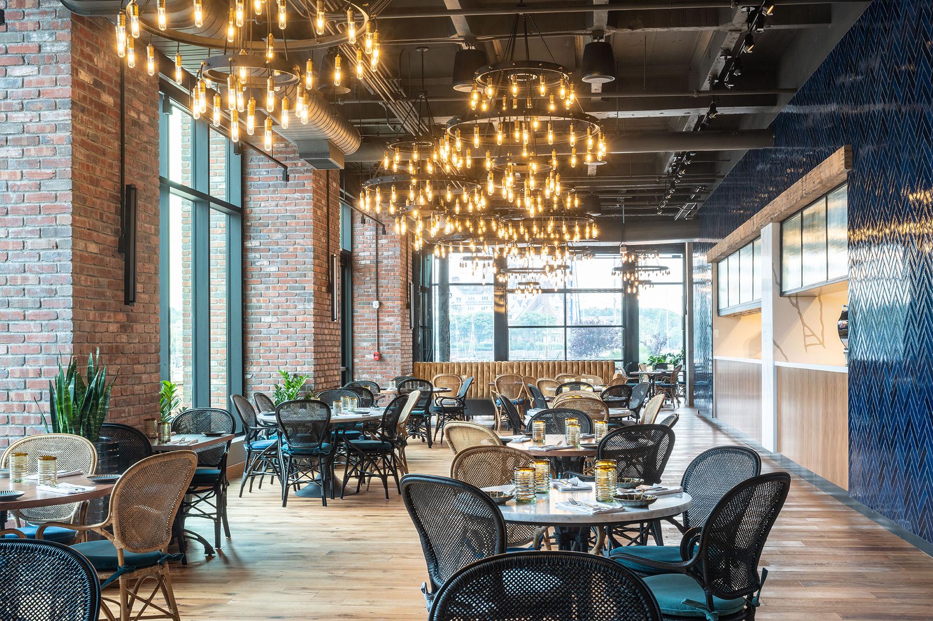 Industrial chandelier installed in a contemporary restaurant with industrial architectural styling.