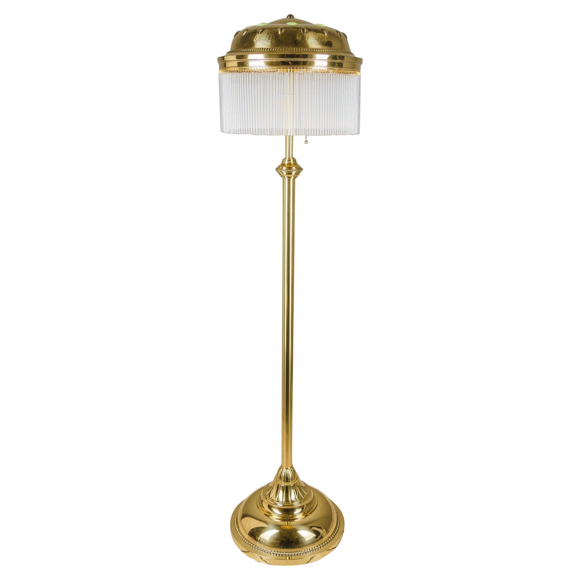 Art Deco floor lamp photographed on a clean white background showcasing geometric forms, luxurious materials and refined finishes.