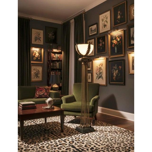 Art Deco floor lamp positioned in a boutique hotel lounge creating a glamorous atmosphere with warm architectural ambient lighting.