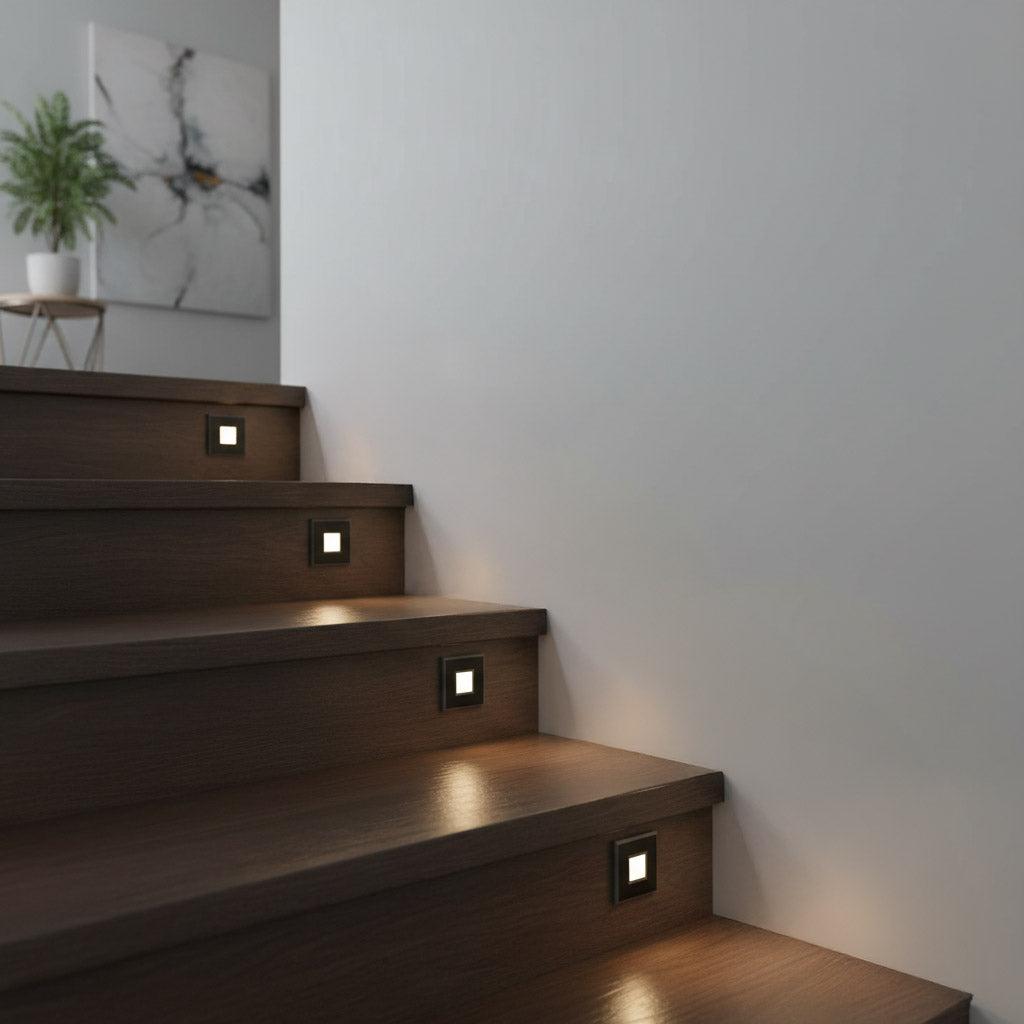 Recessed step lights installed on a contemporary staircase in a hospitality environment.