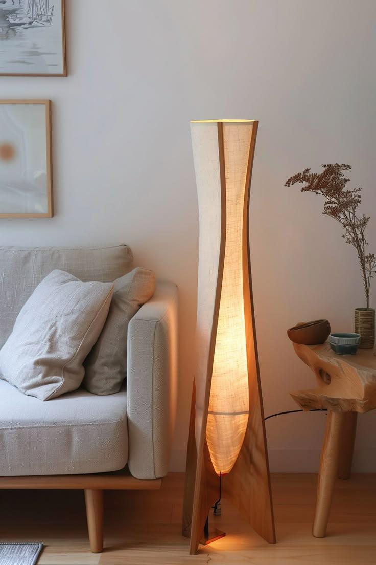 Organic floor lamp positioned beside a lounge chair in a contemporary residential living room creating warm ambient lighting and a calm natural atmosphere.