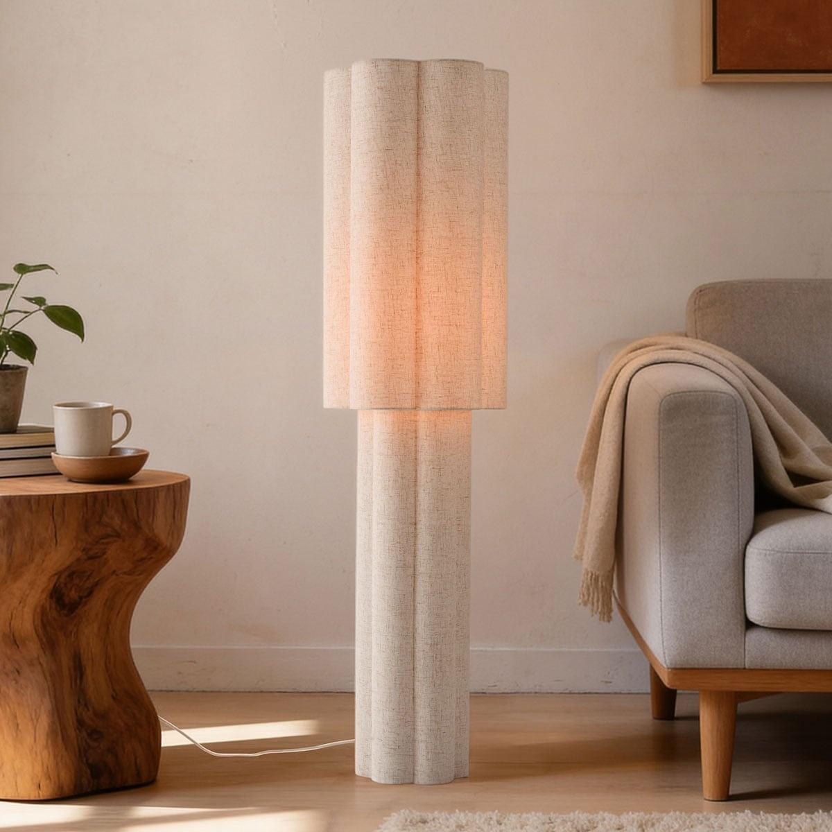 Organic floor lamp positioned beside a lounge chair in a contemporary residential living room creating warm ambient lighting and a calm natural atmosphere.