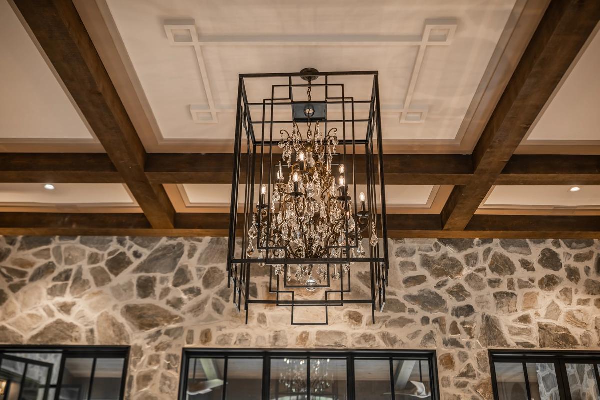 Cage chandelier installed in a contemporary hospitality interior with industrial architectural styling.