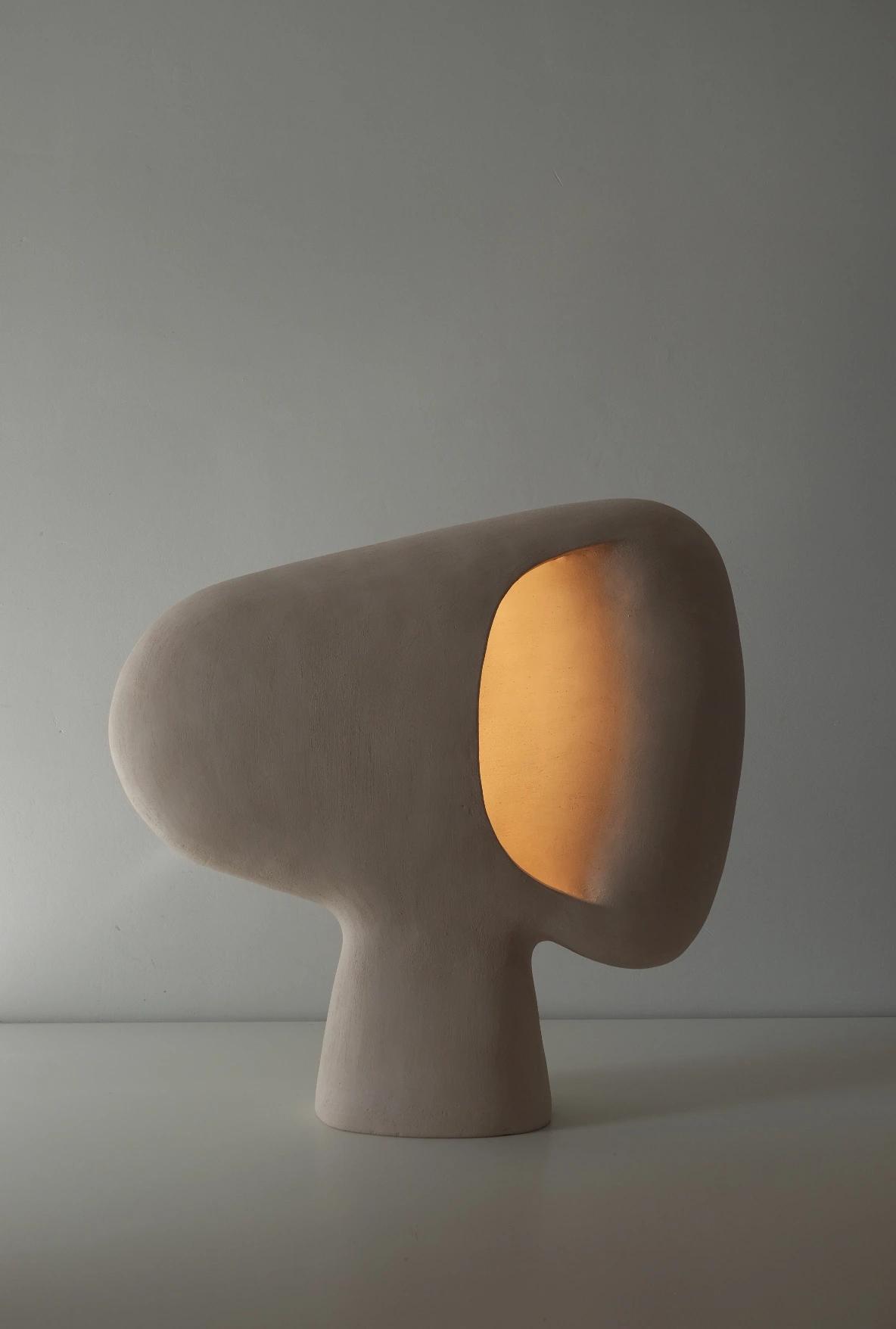 Front view of an organic table lamp highlighting flowing forms and refined craftsmanship.
