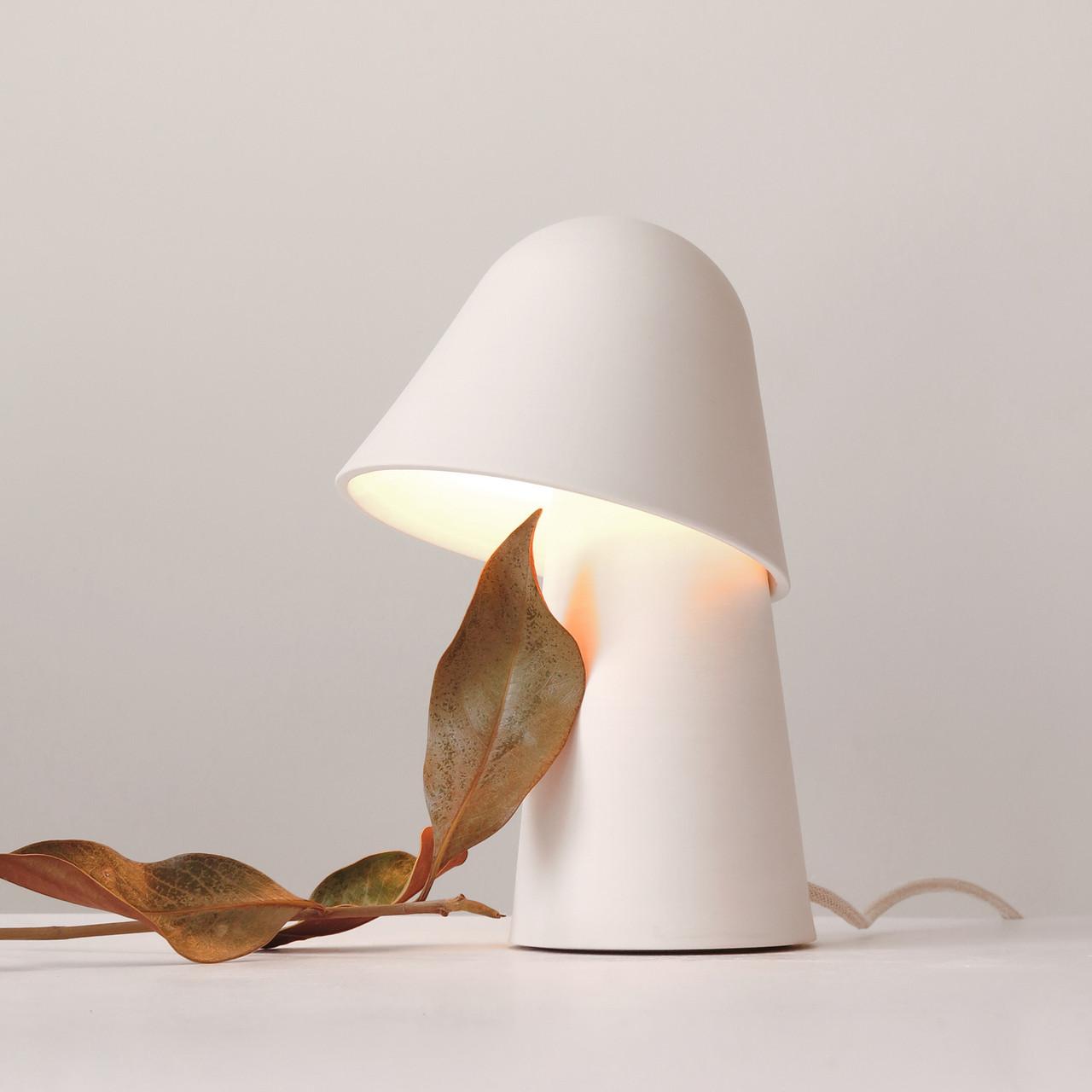 Front view of an organic table lamp highlighting flowing forms and refined craftsmanship.