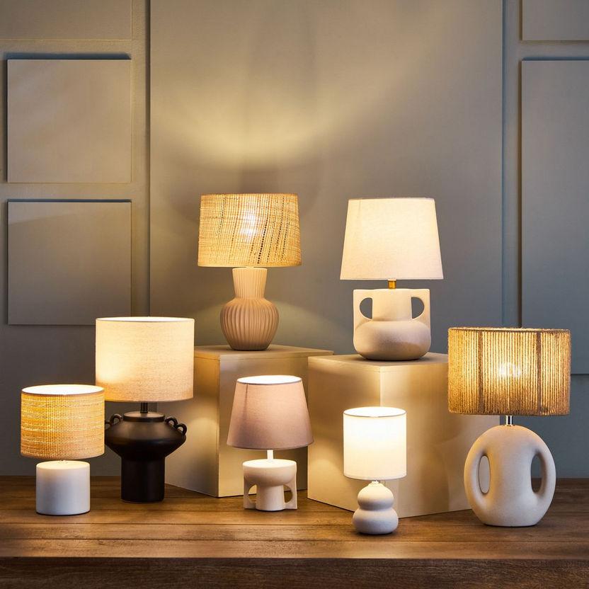 Collection of organic table lamps featuring ceramic, wood and glass elements inspired by nature.