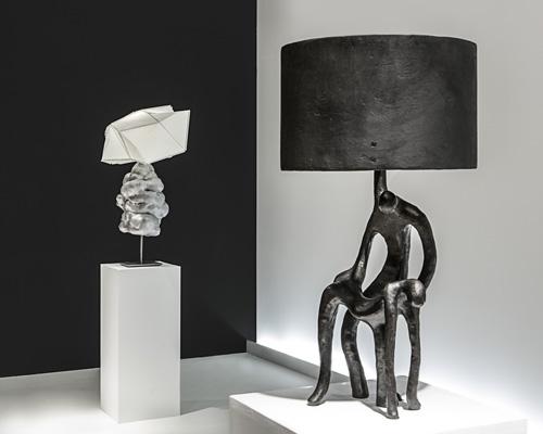 Sculptural table lamp displayed in a luxury hotel lobby creating an artistic focal point with elegant ambient lighting.