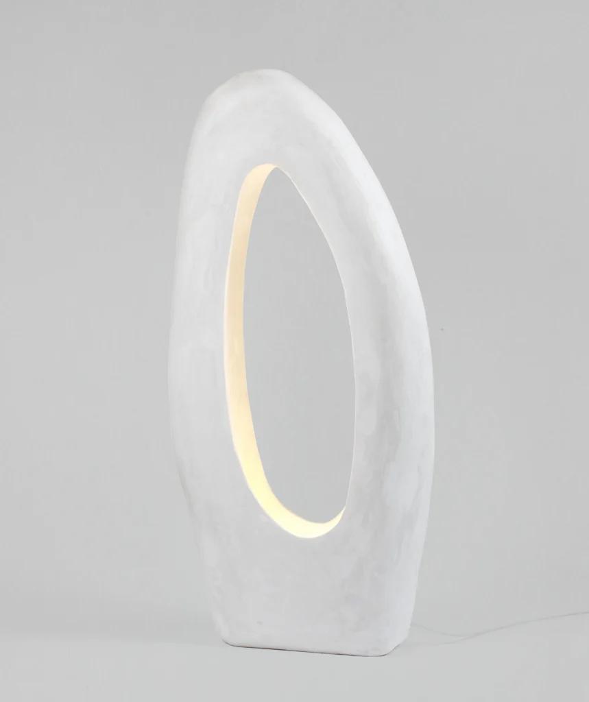 Front view of a sculptural table lamp showcasing expressive geometry and refined architectural detailing.