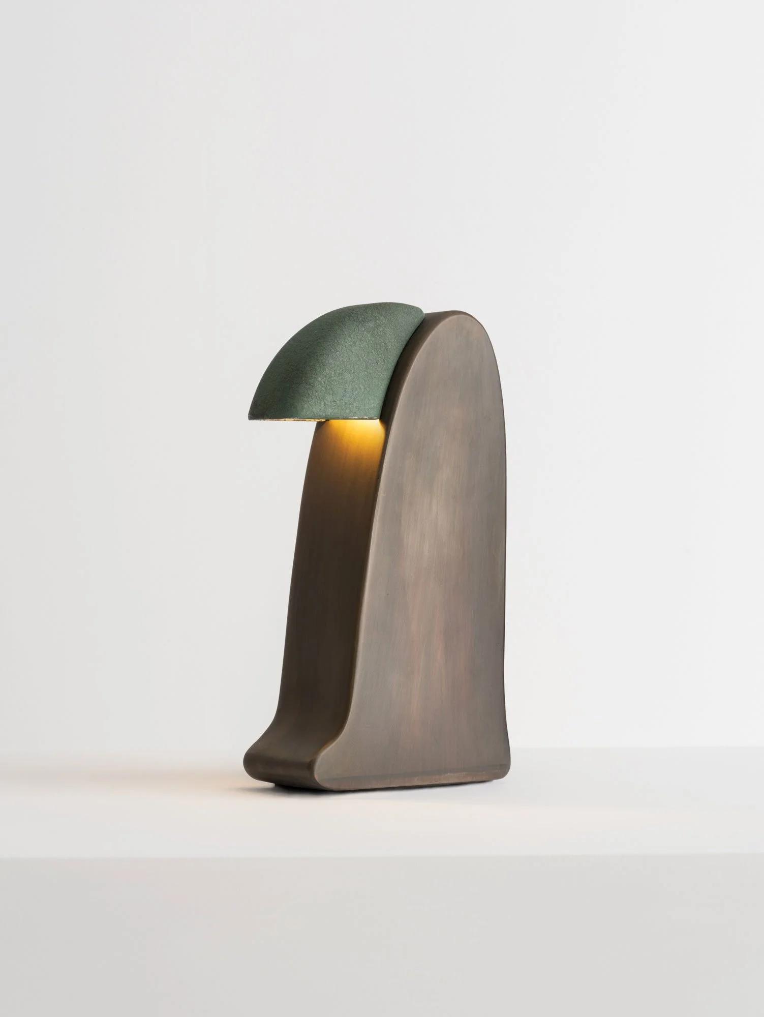 Front view of a sculptural table lamp showcasing expressive geometry and refined architectural detailing.